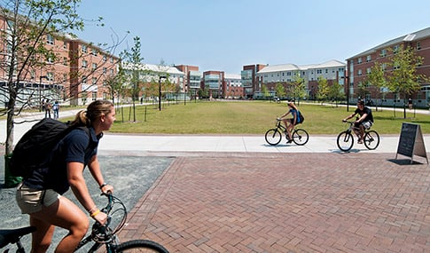 Students bike through Old Dominion University’s campus on a sunny day