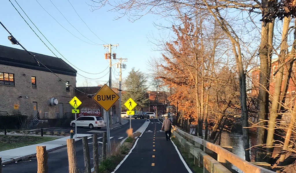 Olneyville resident walking on new San Souci Drive Shared Use Path.