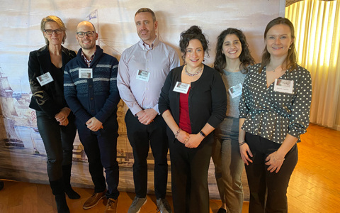 Six VHB team members stand together in the office.