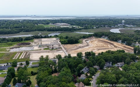 Aerial view of construction site near water. 