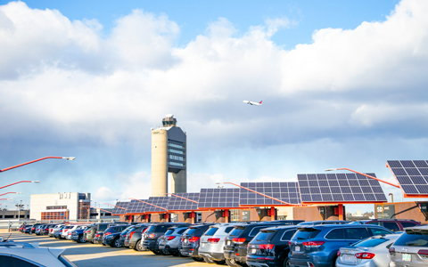 Solar panels line Logan Airport parking facilities.