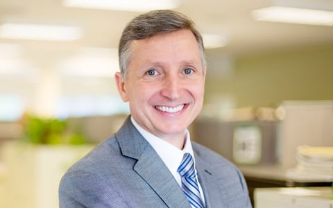 Tim Hogan smiling in an office.