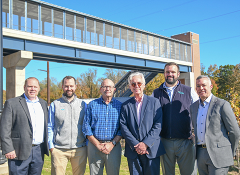 The VHB team stands together in front of the project for a group photo.