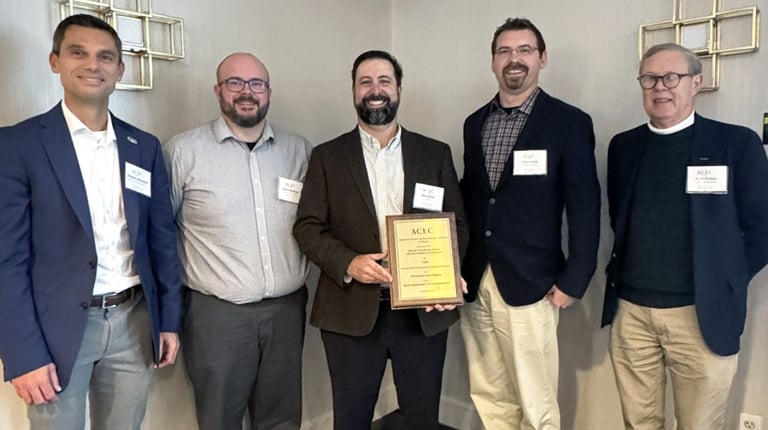 Five men holding up an ACEC Engineering Excellence Award.