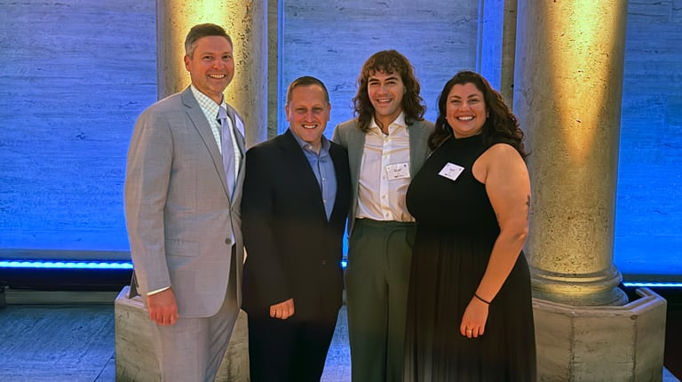 Four VHB team members pose at the 2026 AMFP GNY Awards Gala in front of illuminated columns.