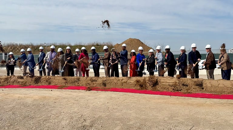 Developers, public agency representatives and project partners pose with shovels at residential groundbreaking. 