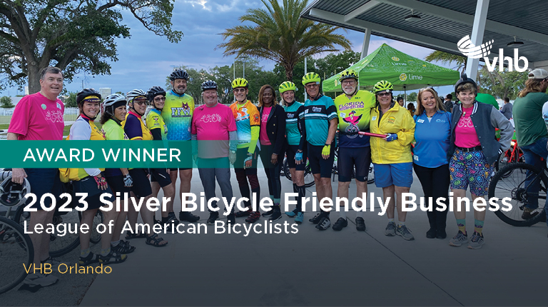 A group of participants wearing bicycle helmets preparing to ride