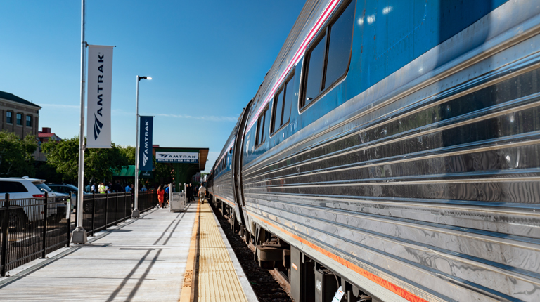 Amtrak train on track with passenger platform.
