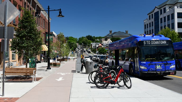Downtown area with bicycles, buses and sidewalks.