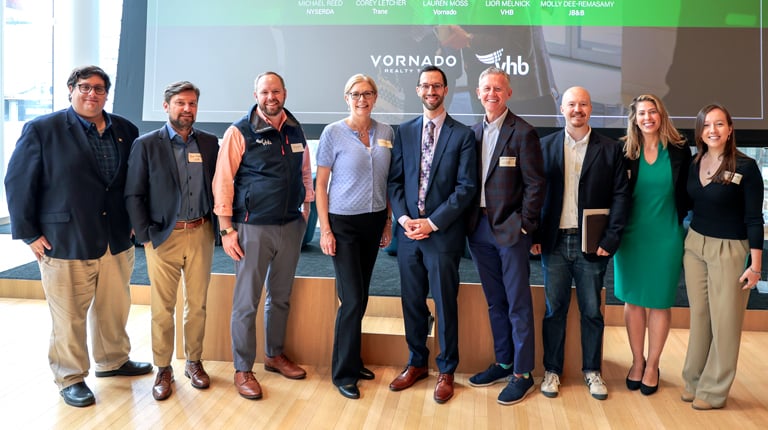 VHB attendees in front of a Climate Week NYC event stage following a panel discussion.