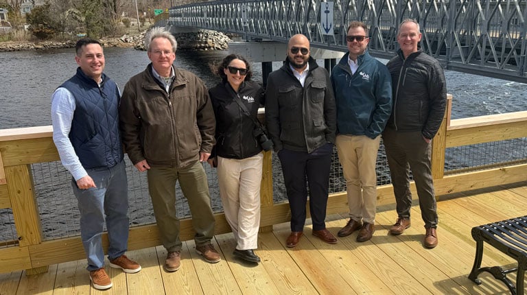VHB’s project team standing on a new riverside fishing platform.