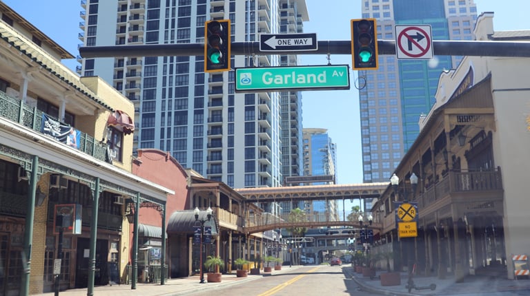 A downtown Orlando intersection with buildings and stoplight. 