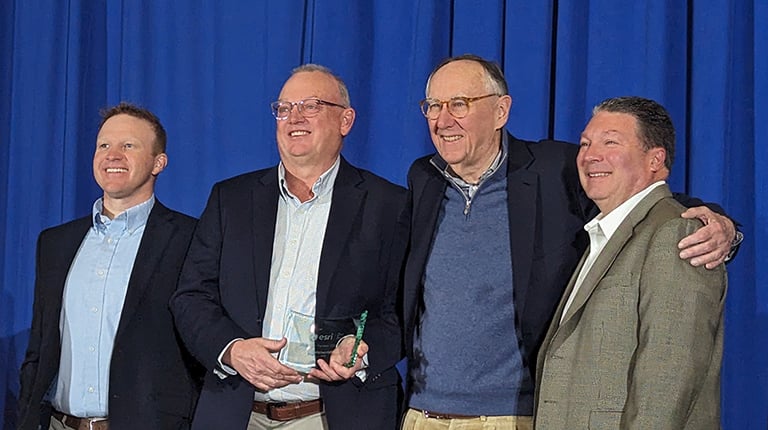Image of award recipients smiling at the camera