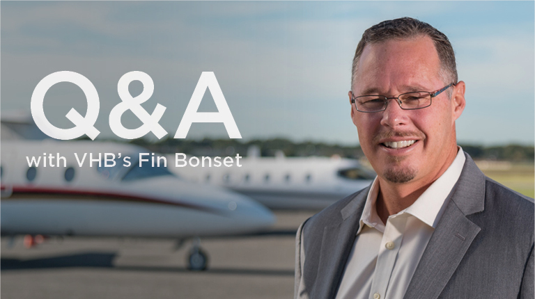 VHB’s Fin Bonset standing on a tarmac in front of a small passenger plane