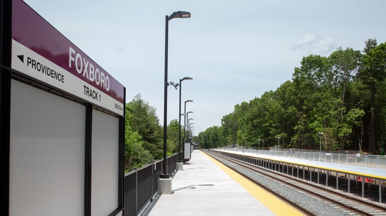 Foxboro Station platform with an MBTA train.