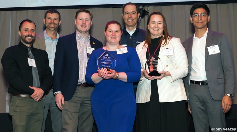 NOON Ingram project team smiling at the camera holding their award.