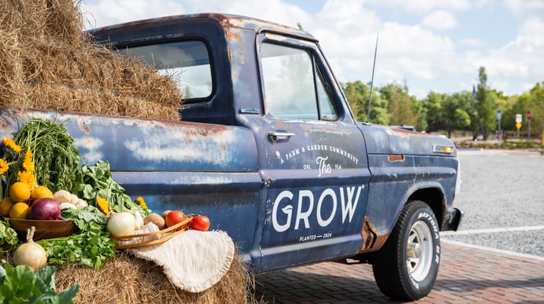 An old truck with the words The Grow painted on the side.