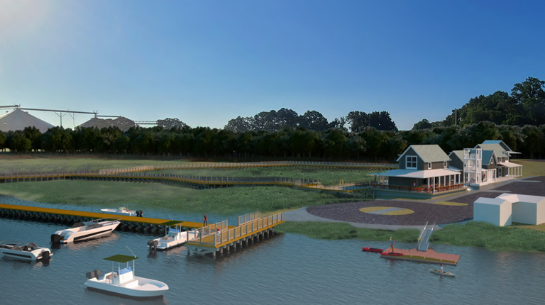 View of the existing parking lot, small dock, and pump station on site from Hoskins Creek.