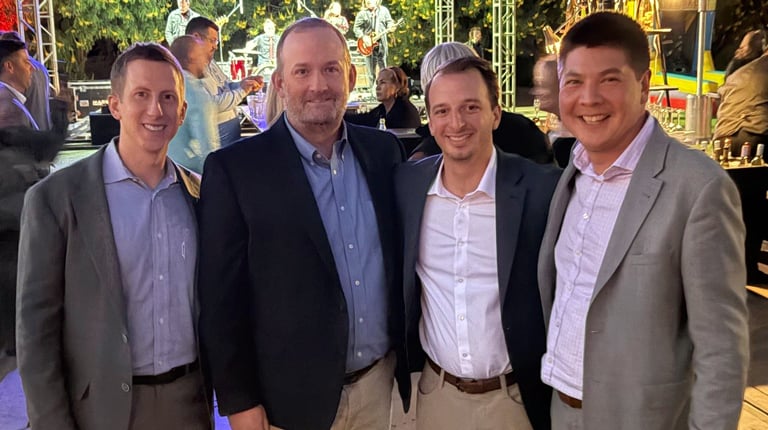 Peter Doster, Rick Dupuis, Jon Moser Andree Nee outside at dusk at the ICSC Conference.