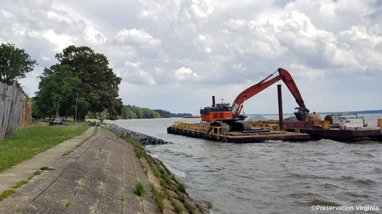 Construction equipment in the water for the seawall repair project at historic Jamestown.