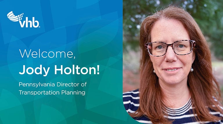 Jody Holton outside smiling in a striped top. 