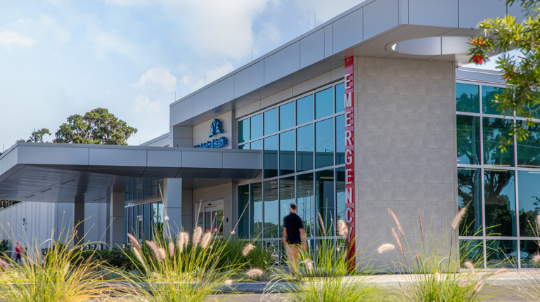 An emergency department with native plants in front.