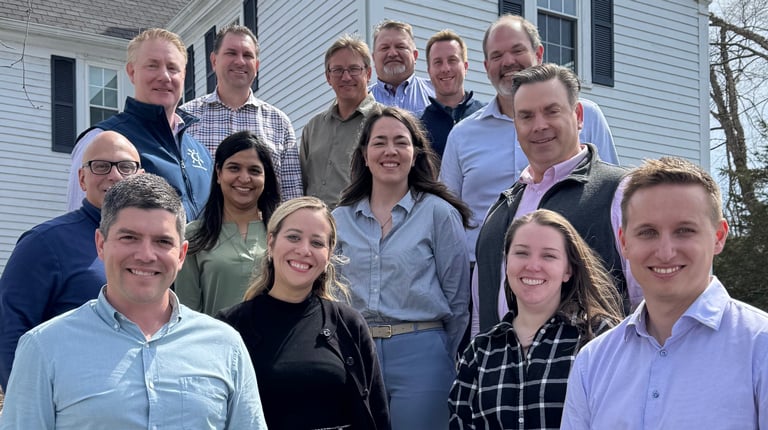 Group photo of Spring 2025 VHB LEADS program participants standing on stone steps outside the Warren Conference Center in Ashland, Massachusetts.