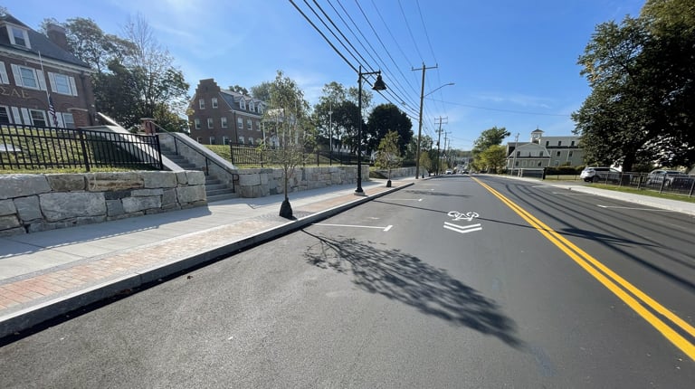 Improved Madbury Road corridor in Durham with bike lane and sidewalk.