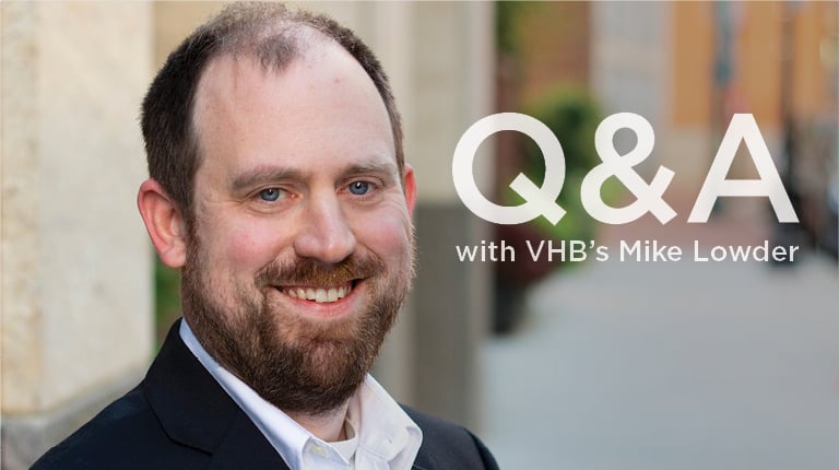 Professional headshot of Mike Lowder on a sidewalk in front of a building.