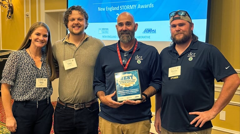 Four individuals posing with the "Best Stormwater Idea in New England" award at the New England Stormy Awards ceremony.