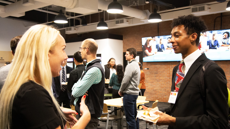 VHB employees and Northeastern alums mingle with NU students at a VHB open house.