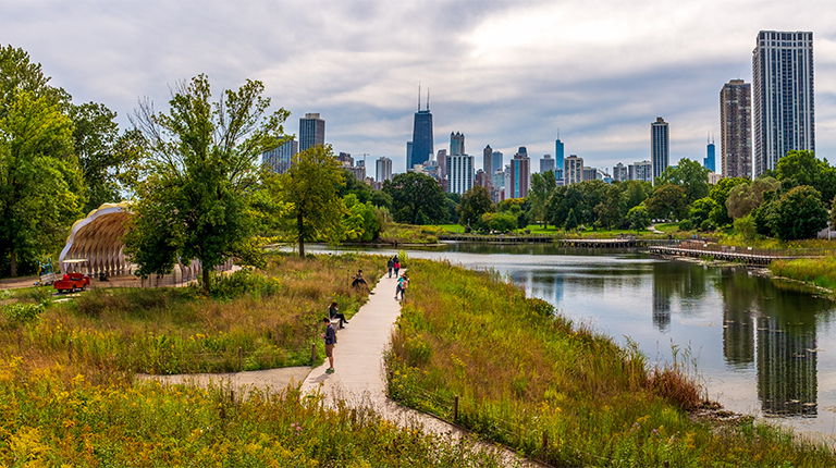 View of Jackson Park with walkways, water, and Chicago skyline in background