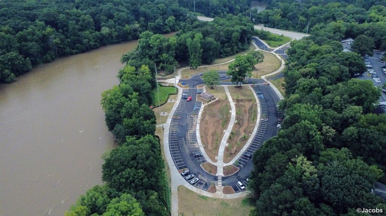 A bird’s eye view of a park along a river.