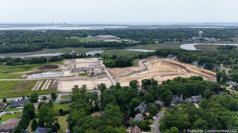 Aerial view of construction site near water. 
