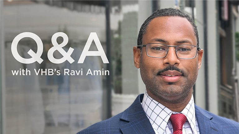 Ravi Amin in a blazer and glasses.