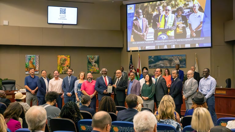 he VHB team stands alongside Mayor Demings in a formal pose.