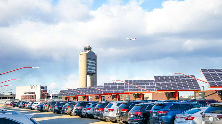 Solar panels line Logan Airport parking facilities.