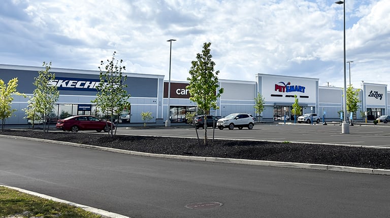 View of shops and parking area at the Springfield Crossing mall.