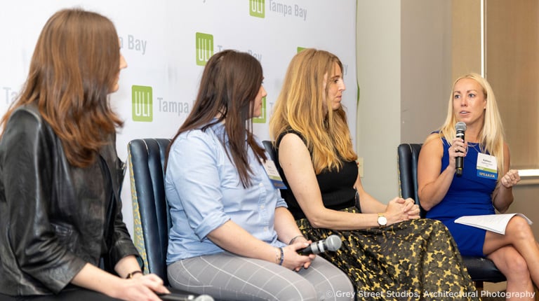 A group of women on stage at an industry panel event.