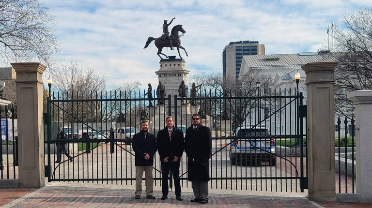Members of the project team stand in front of the newly constructed Virginia State Capitol security gate.