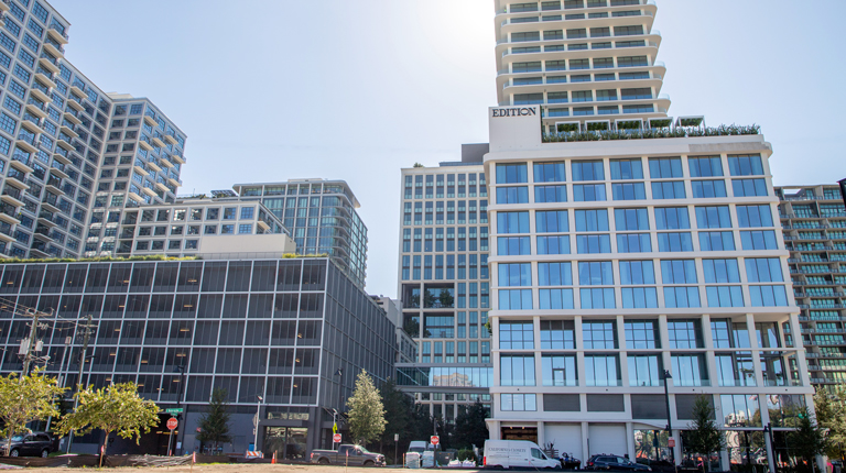 Tall office buildings in an urban setting with trees.