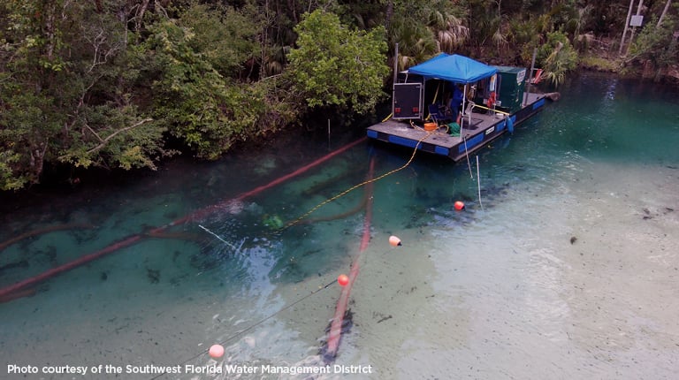 A boat with equipment for sedimentation surveys on a river.