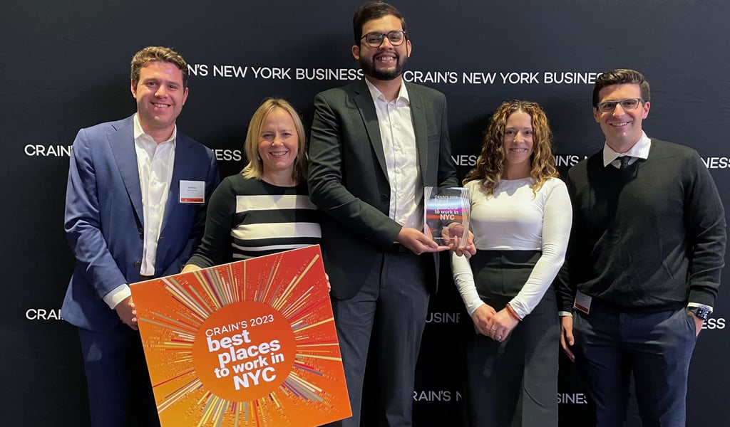 VHB team members posing with the Crain’s Best Places to Work award.