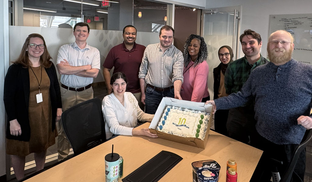Group of VHBers celebrating with cake.