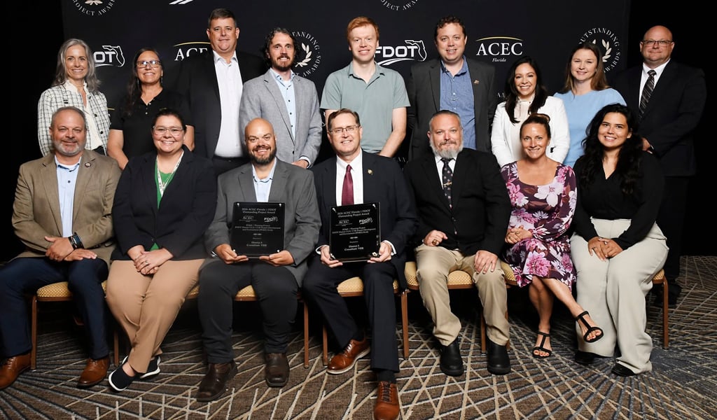 Group of VHB team members pose with awards at ACEC Florida event in front of branded backdrop for PD&E Project recognition.