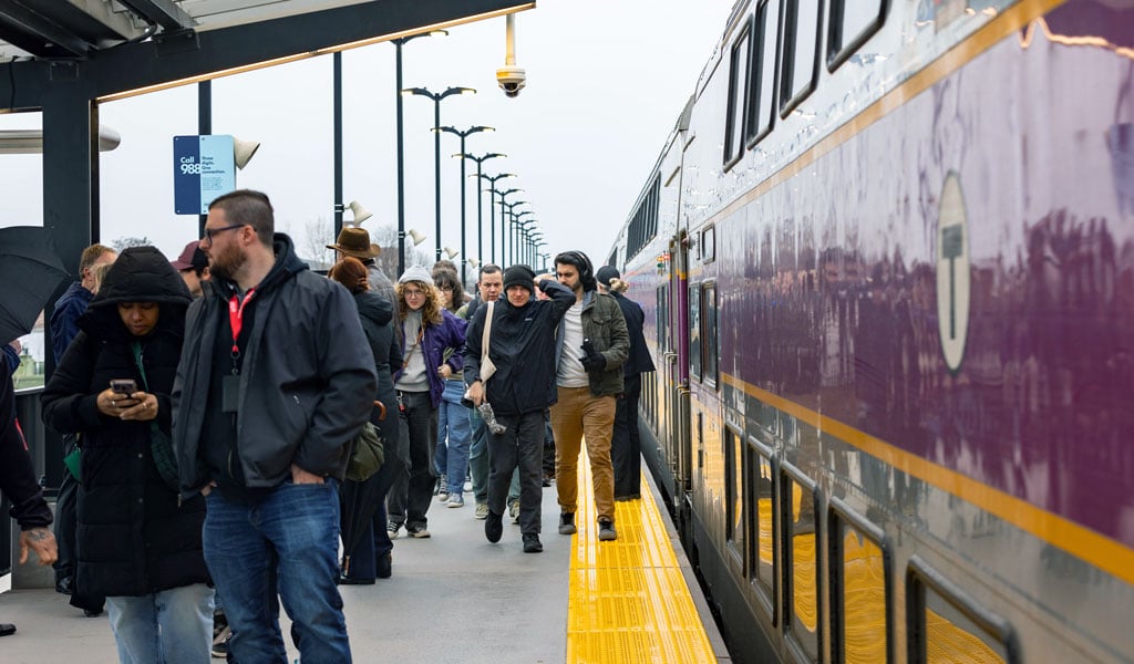 Passengers on a train station platform exiting a train