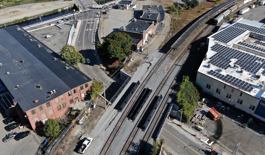 Aerial view of a bridge carrying three railroad tracks over a street