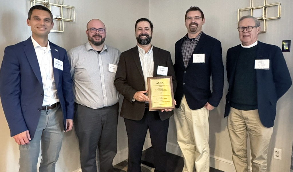 Five men holding up an ACEC Engineering Excellence Award.