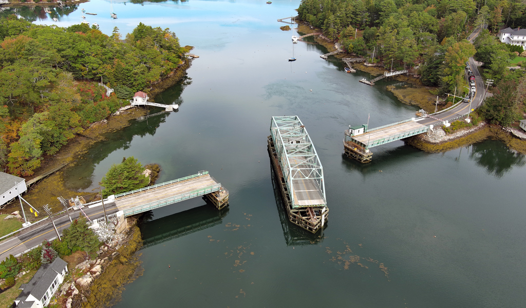 A swing bridge in the open position to allow large boats to pass through the water.