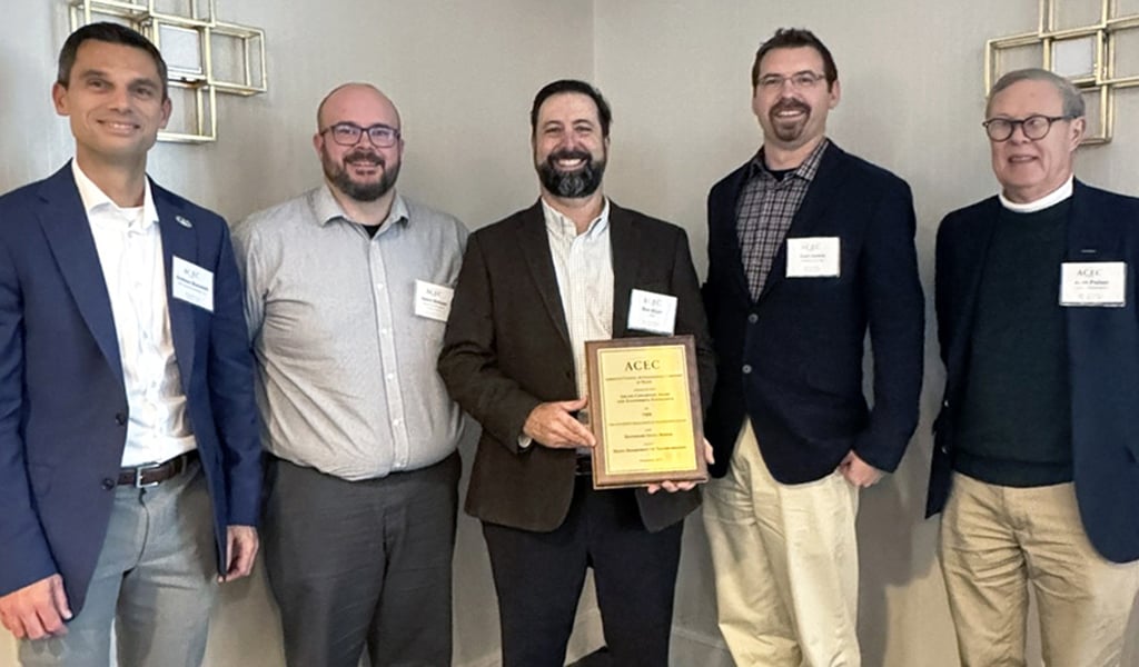 Five men holding up an ACEC Engineering Excellence Award.
